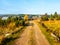 Country road in Jizerka village on sunny autumn day, Jizera Mountains, Czech Republic