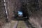 Country road with light in the tunnel