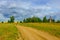 Country road before the rain church in the distance dark sky