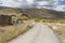 Country road and ruins of ancient rustic houses next to Nacimiento village