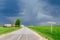 Country road with a signpost before rain