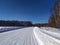 Country road through snow-covered fields, countryside. View from the car. Snow drifts. Nature, Christmas holidays