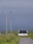Country road, telegraph poles and cottage on Island of Tiree, Scotland