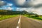 Country road under huge clouds