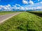 Country road with wind turbines in polder, Netherlands