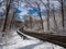 Country Road Winding Through Forest in Winter