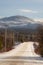 Country road in winter with view of frozen Mount