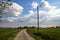 Country road with a wooden electricty pylons next to fields in the italian countryside in spring