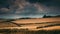 A country track heading off into the distance under a very stormy sky.