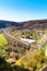 Countryside aerial view with railroad, mountains, houses and green field