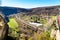 Countryside aerial view with railroad, mountains, houses and green field