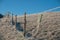 Countryside electric fence for animal covered with hoar-frost. Farm fence in perspective