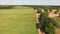 Countryside with farm fields and a dirt road. Aerial view.