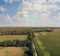 Countryside with farm fields and a dirt road. Aerial view