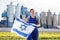 in countryside,frustrated worker in overalls stands in front of factory building with Israeli flag