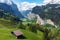 Countryside, green grassland, pine forest, a house and Alps mountain range in summer at Lauterbrunnen, Switzerland