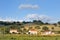 Countryside hill, land and house and wind turbine