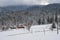 Countryside hills, groves and farmlands in winter remote alpine mountain village