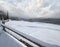 Countryside hills, groves and farmlands in winter remote alpine mountain village