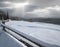 Countryside hills, groves and farmlands in winter remote alpine mountain village