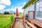 Countryside house exterior with walkout deck and small patio are