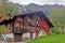Countryside house, farm, mountain, green field, footpath in Switzerland