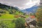 Countryside house, mountain, green field, footpath in Switzerland