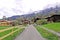 Countryside house, mountain, green field, footpath in Switzerland