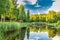 Countryside House near Lake and Forest Panorama. Sunny Summer Landscape With Blue Sky and White Clouds