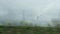 Countryside landscape and grey sky, inside car view.  Car rides fast on highway with green trees by sides