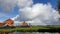 Countryside landscape of Netherlands with rainbow behind the cloud.