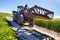 countryside landscape with a tractor with a pitchfork to handle the spreading tractor and its fork in the middle of country lanes