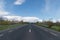 Countryside lanscape. Empty asphalt road in empty fields and cloudy sky .