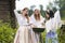 Countryside Lifestyle Concepts. Three Tranquil Caucasian Girls Together in Traditional Rural Dress With Basin of Linens