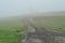 A countryside road on green hills pasture