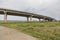 Countryside road passing under a highway bridge