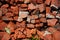Countryside road surface made of broken red bricks.