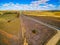 Countryside road winding through agricultural lands.