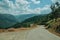 Countryside roadway passing through hilly landscape