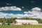 Countryside Rural Paddock For Horse, Shed Or Barn Or Stable With Haystacks In Late Summer Season.