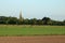 Countryside scene, church, fields, shorn sheep