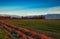 Countryside scenery with the mountains in distance at sunset. Beautiful landscape with meadows rolling through valleys