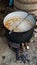 Countryside wood burning big cast iron pot. Outdoor pottage cooking traditional cuisine meatballs soup