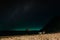 A couple admires the night starry sky in sun loungers on the beach. A quiet tropical night on the Paradise island of Koh