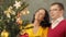 Couple admiring Christmas tree, happy family embracing heartily, togetherness
