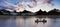 Couple adventurous people on red canoe paddling in calm water.