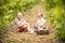 Couple of alternative aged older traveler stay sitting down in a vineyard with the luggage and playing an ukulele acoustic guitar