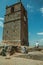 Couple around stone tower with bell and clock in Monsanto