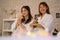 Couple Asian women with spa robe enjoy to take care skin with skin lotion or cream in room wait for spa and massage in room