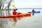 Couple of athletic men engaged in speed rowing